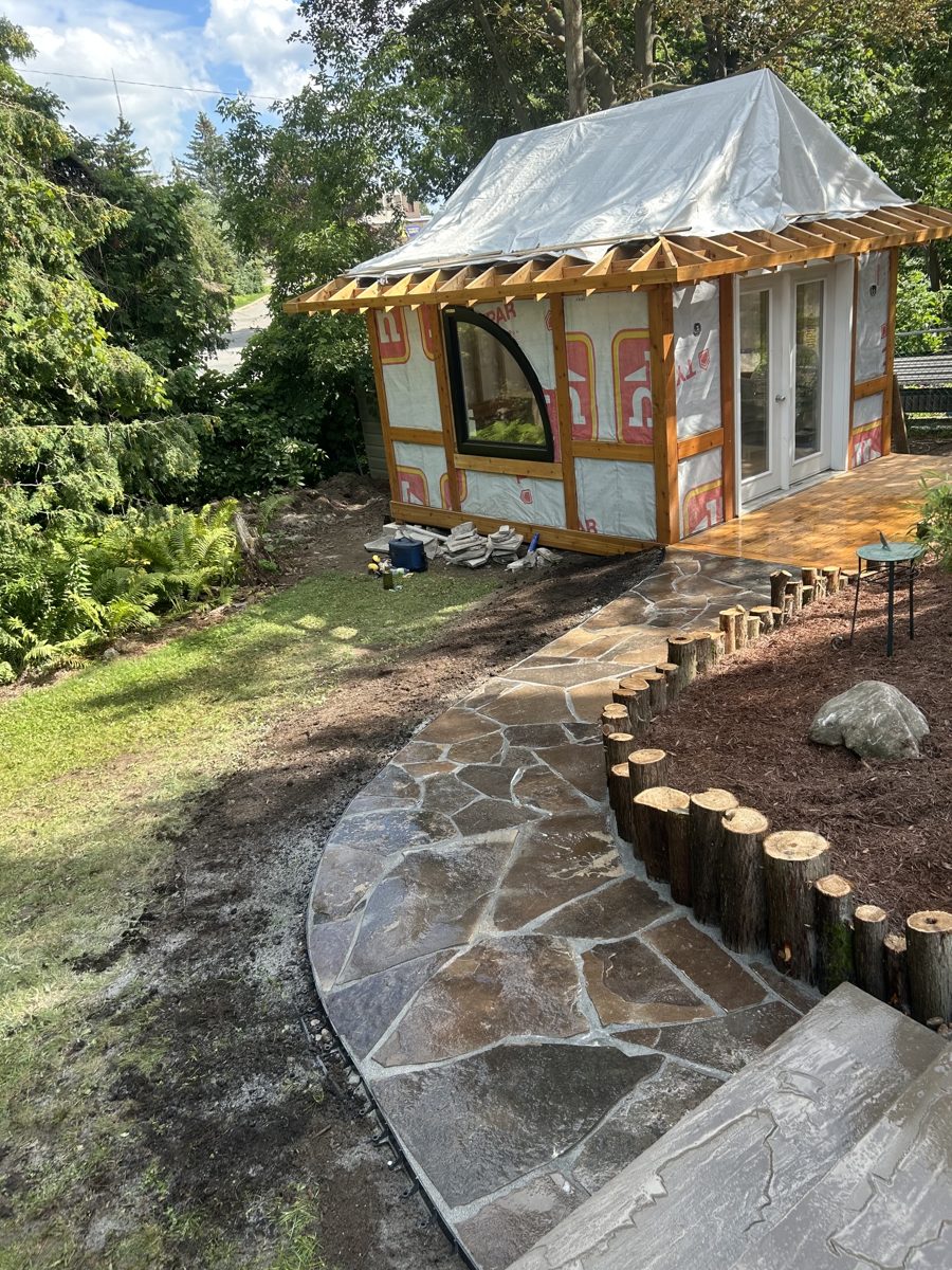 Curved flagstone path to a garden studio — Peterborough