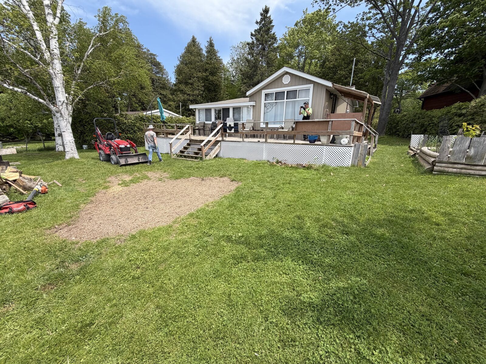 Bare lakeside yard at a Chemong Lake property before the pergola and patio build